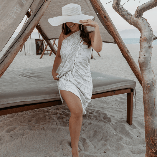 Woman wearing a Turkish towel as a sarong on the beach