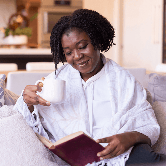 Why did my Turkish towel get stiff? Woman wears Turkish towel as shawl as she reads a book