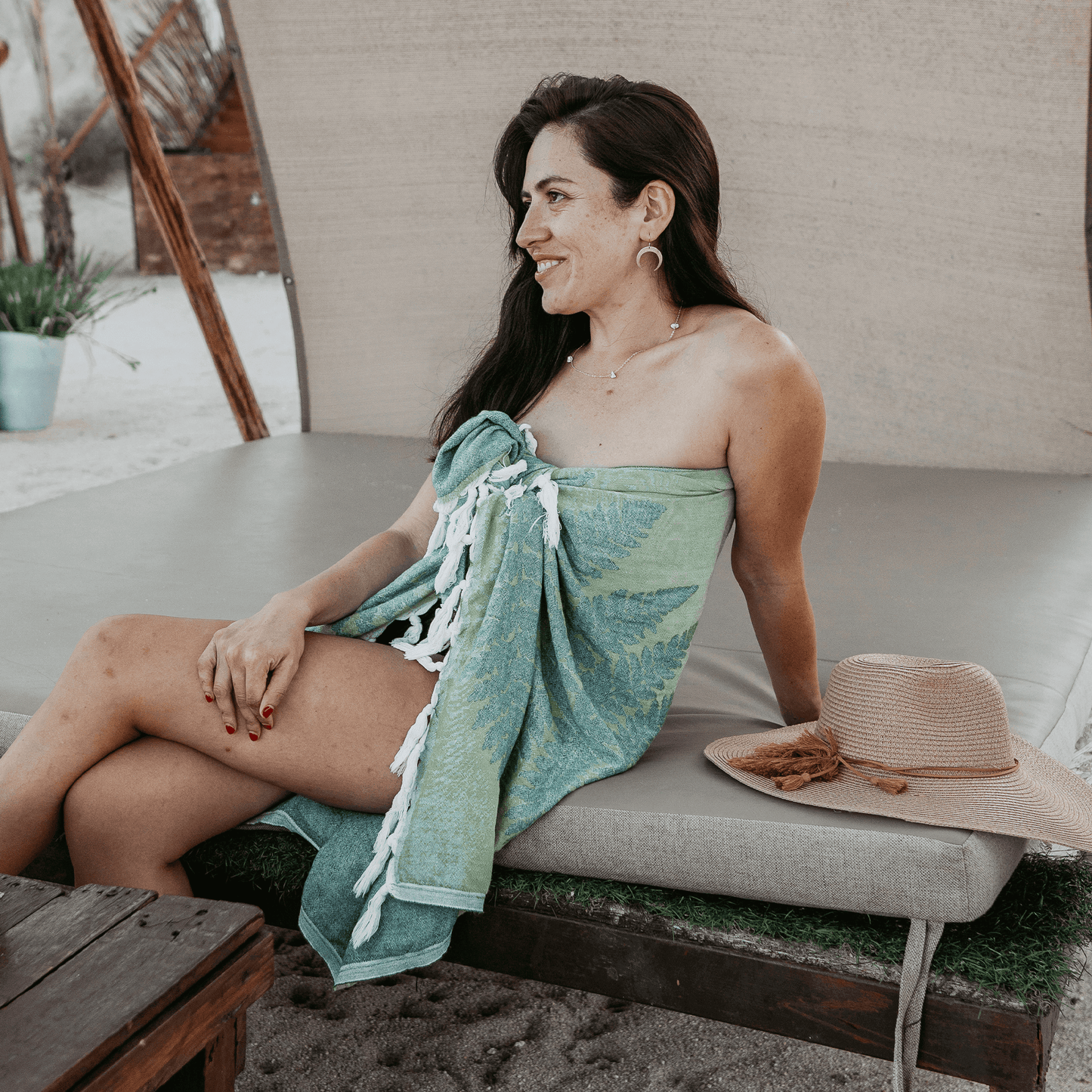 woman wearing her Turkish towel as a sarong at the beach