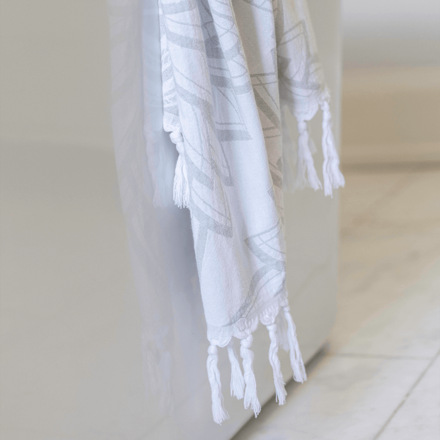 Turkish towel hanging on the side of a bathtub