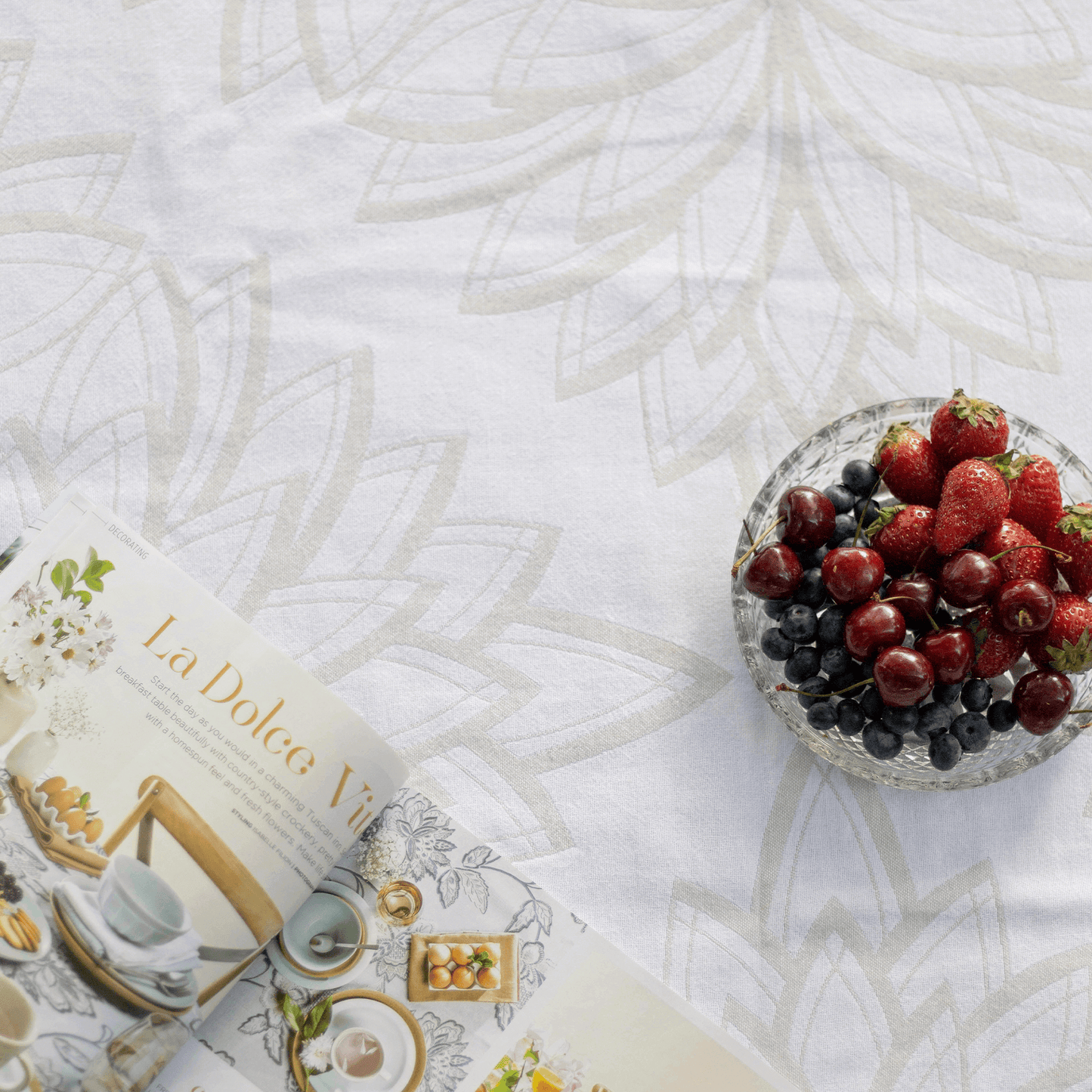 Turkish towel with strawberries and an open magazine