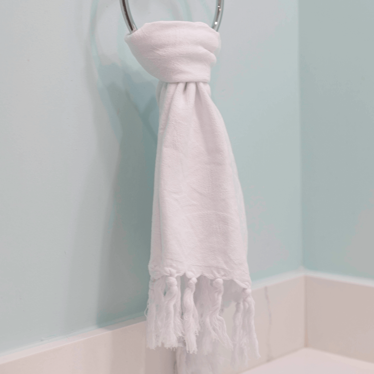  White Turkish towel hanging on hand towel rack