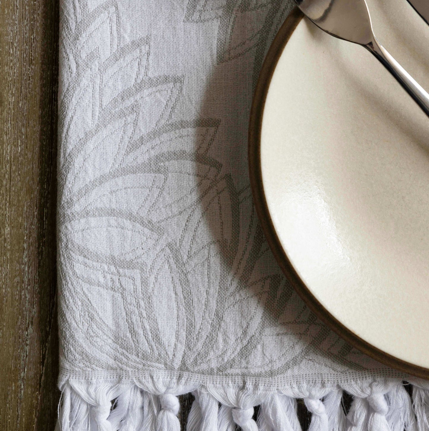 Grey and white Turkish towel with plate