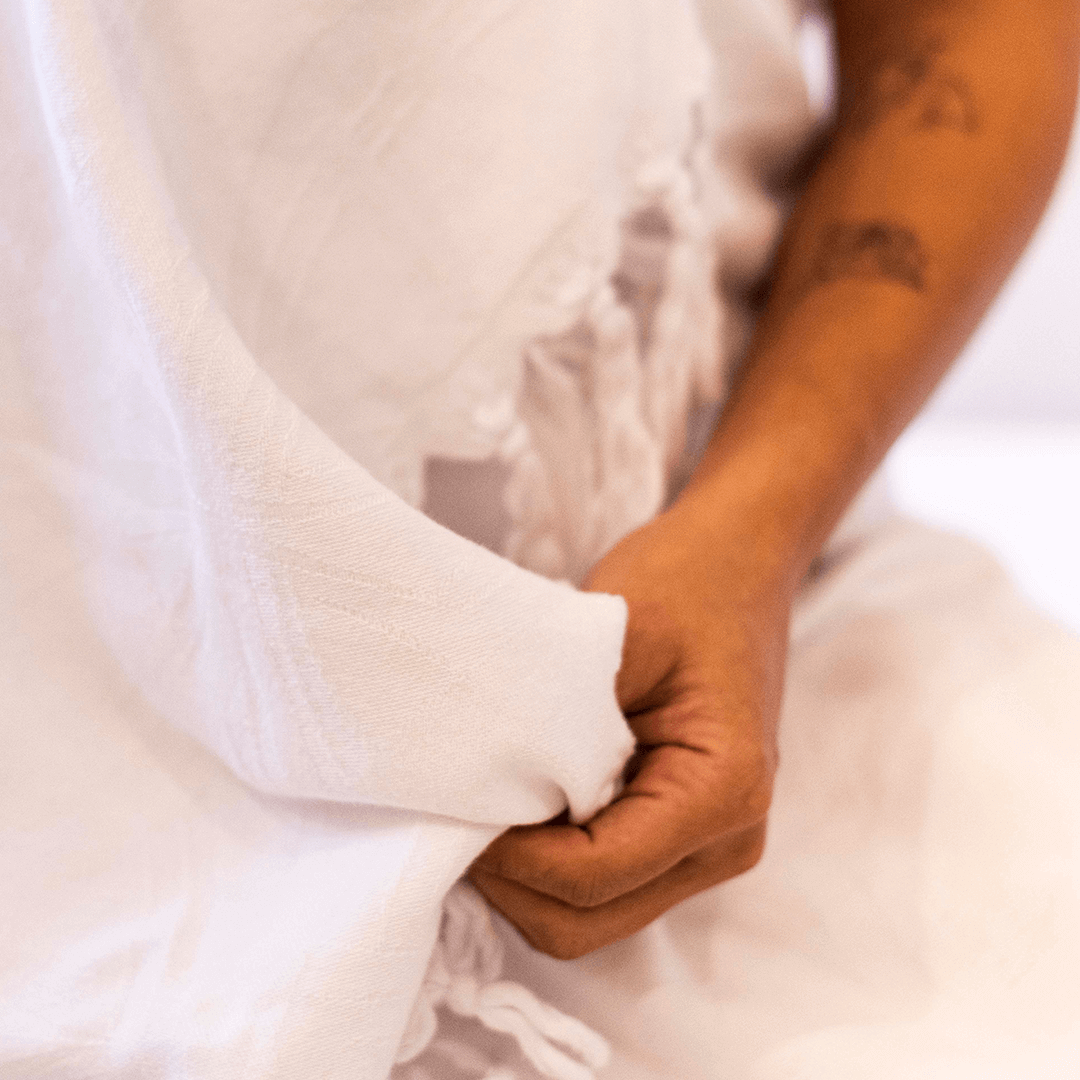 Smiling woman in a white Turkish towel in the bath