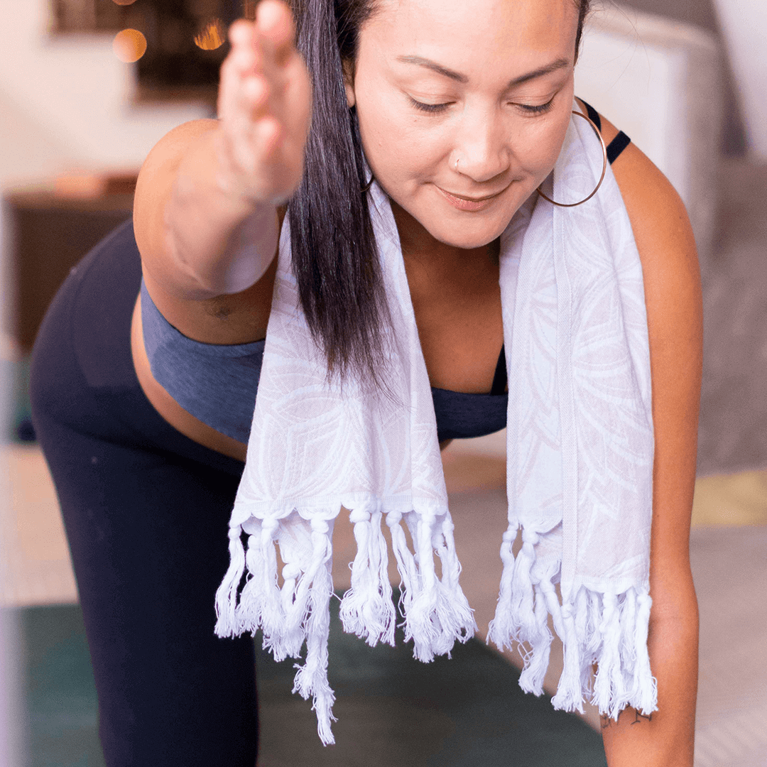 smiling woman using a Turkish towel after yoga