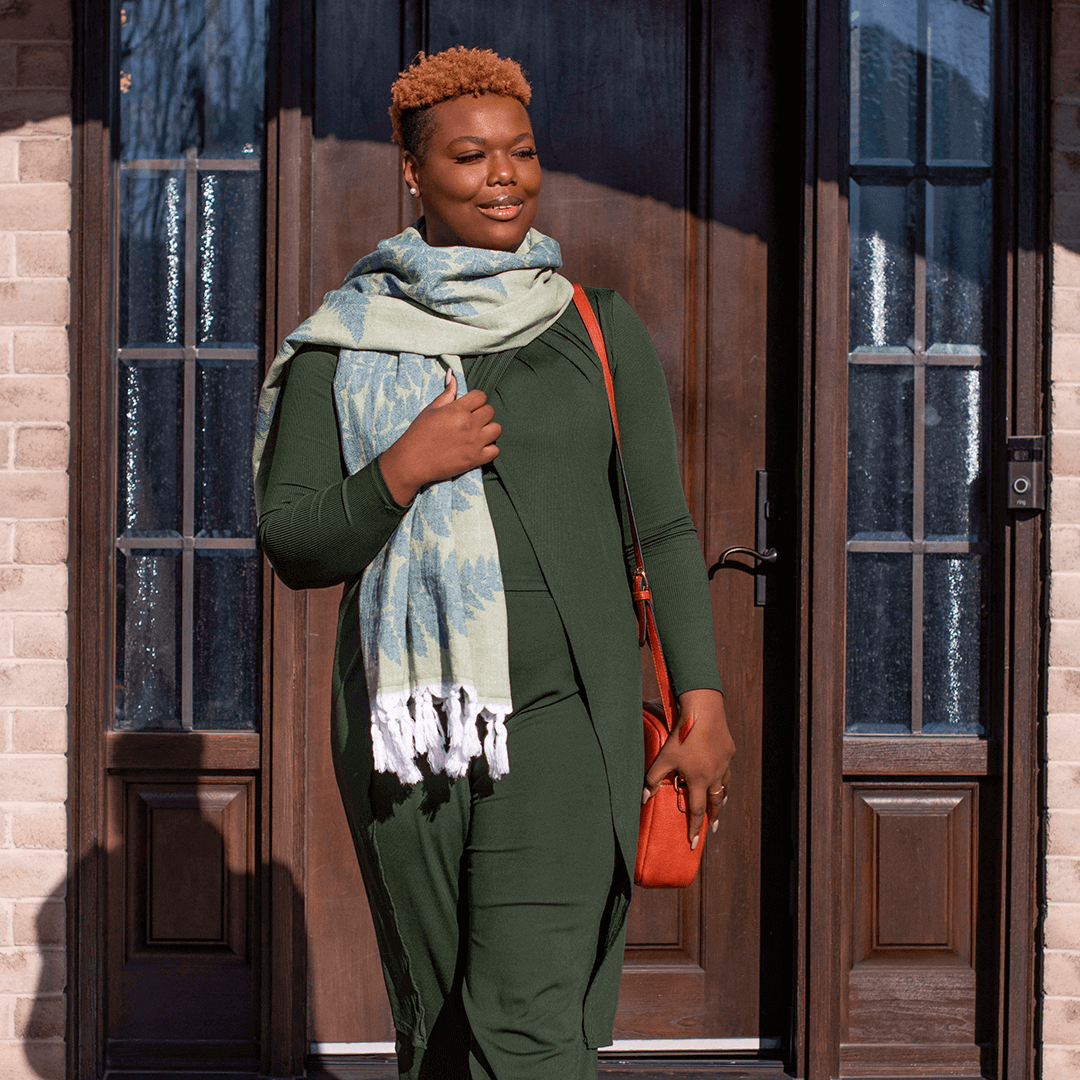  smiling woman wearing Green fern set of Turkish towels as a scarf