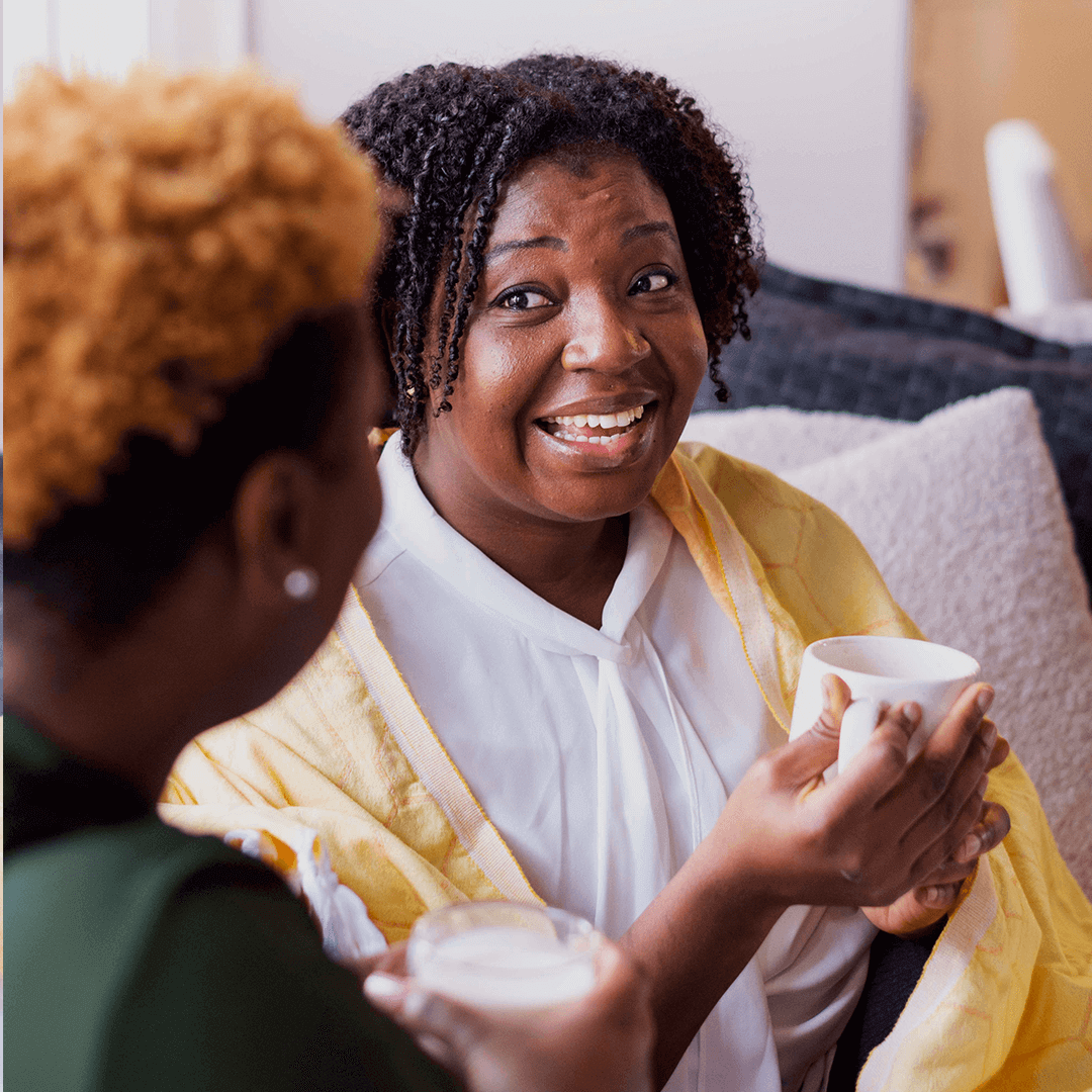 smiling woman using a yellow Turkish towel as a light blanket