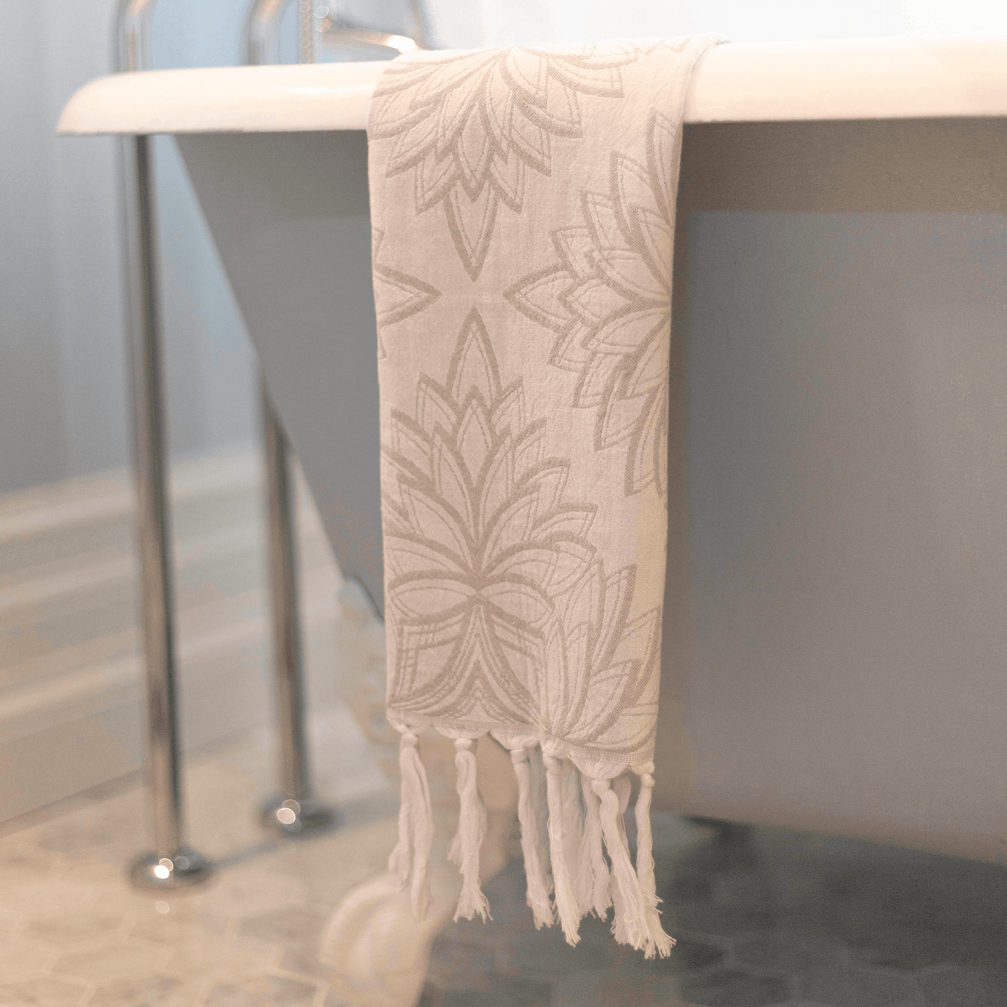 Grey and white Turkish hand towel hanging in the bath