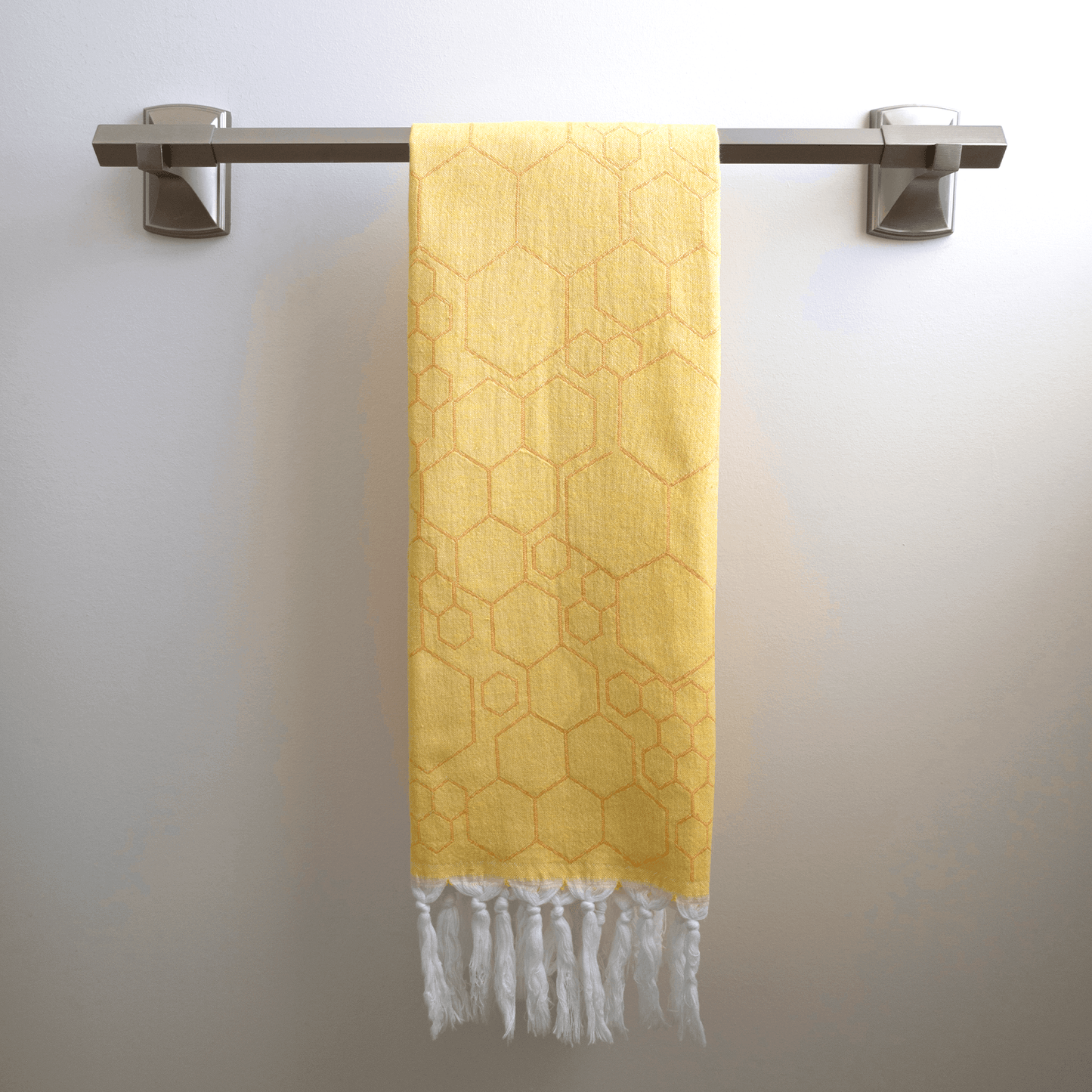 Yellow Turkish hand towel on the towel rack