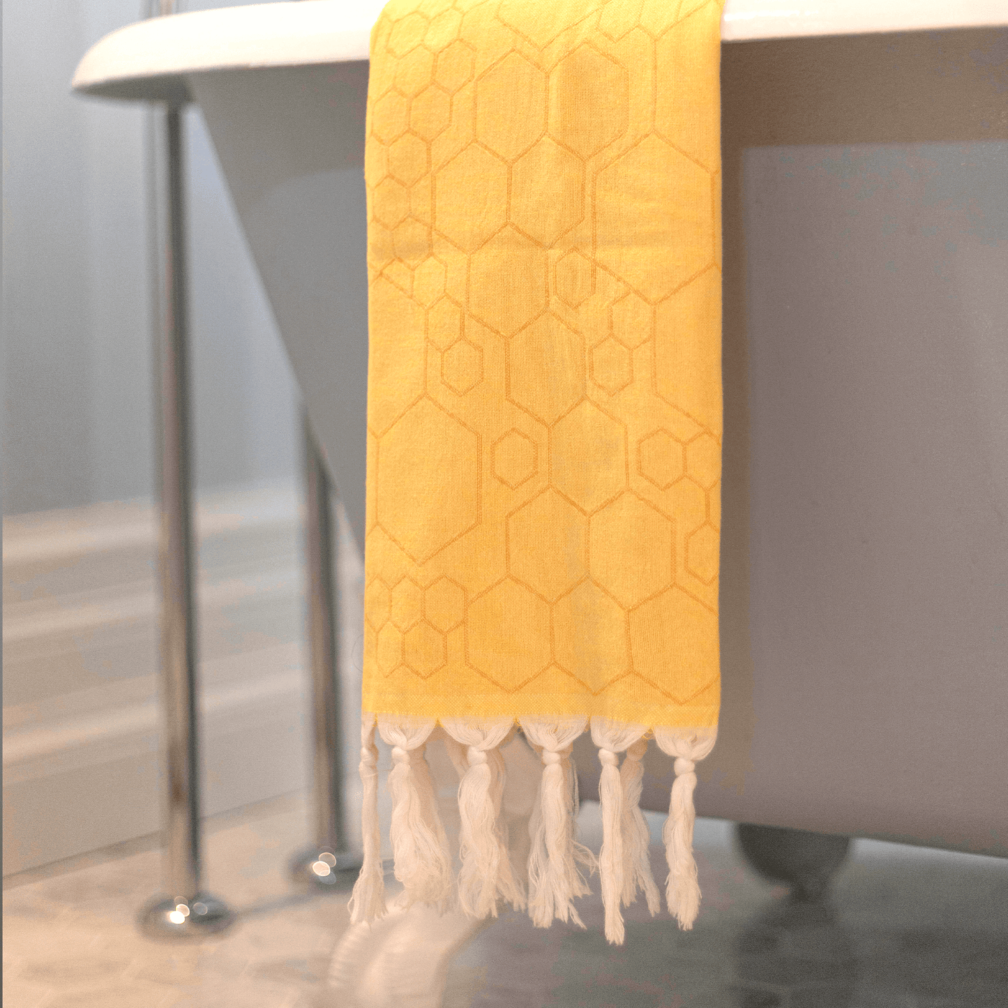 Yellow Turkish hand towel hanging in the bath