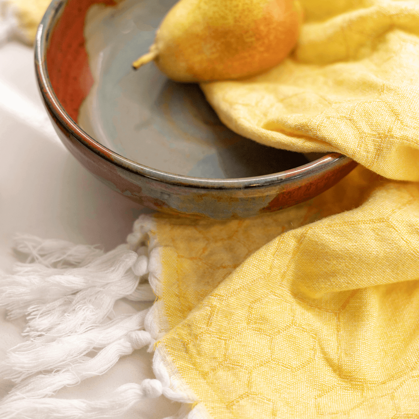 Yellow Turkish hand towel in the kitchen with a bowl