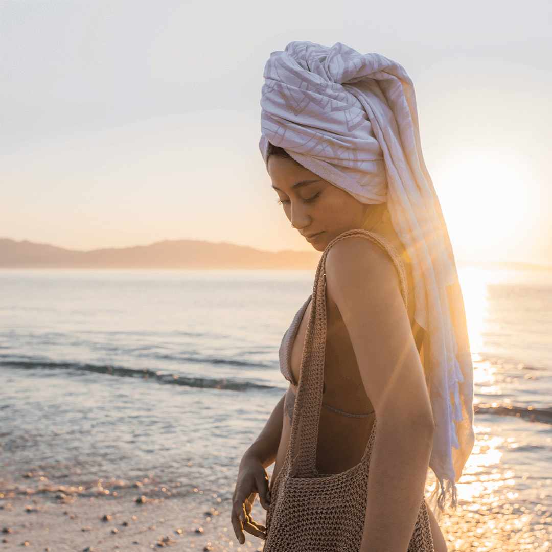 Are Turkish towel good for hair? A woman wears Turkish towel in hair at the beach
