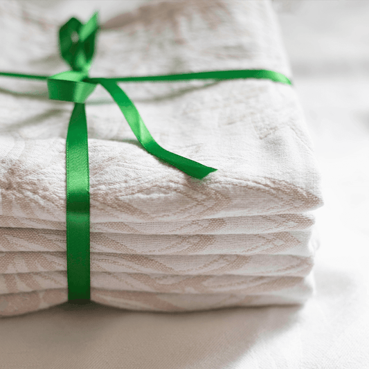 Turkish towels in oat tied with a green bow