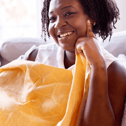 Smiling woman with yellow honeycomb Turkish towel