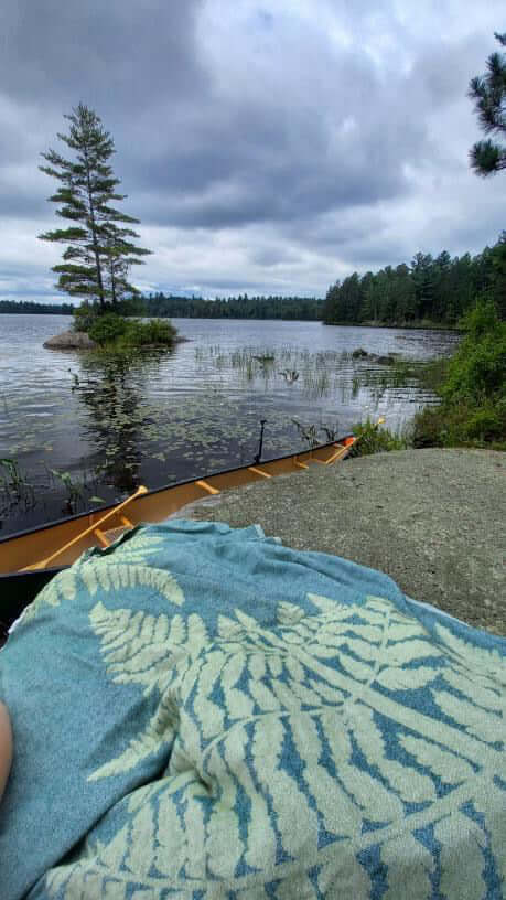 Turkish towel by a canoe and lake. Ontario Canada cottage core