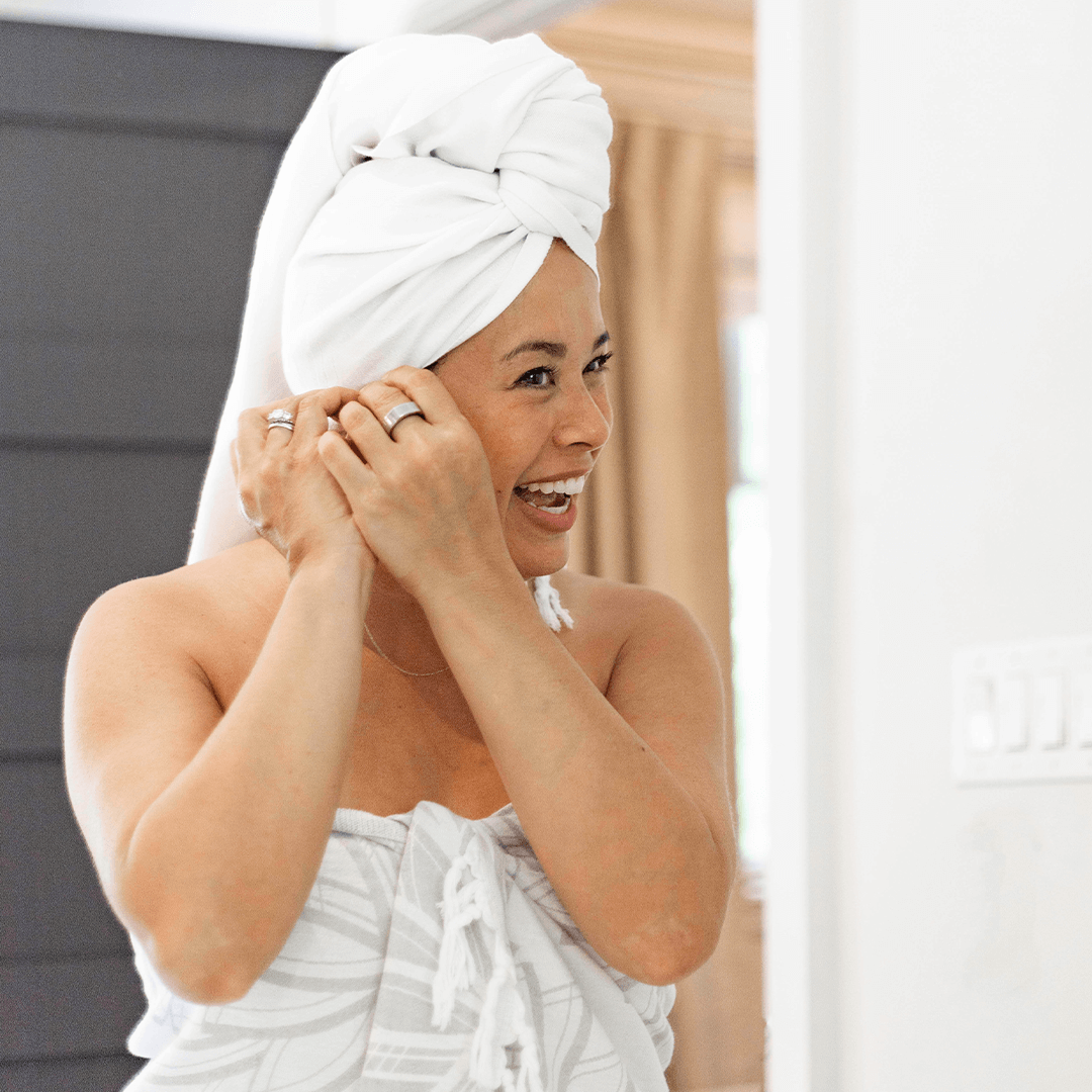 Smiling woman with a white Turkish towel in her hair