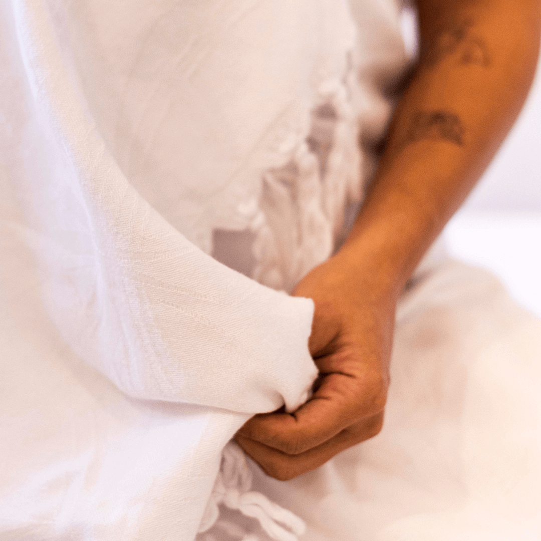 What are Turkish towels made of. Woman's hand touches the white Turkish towel