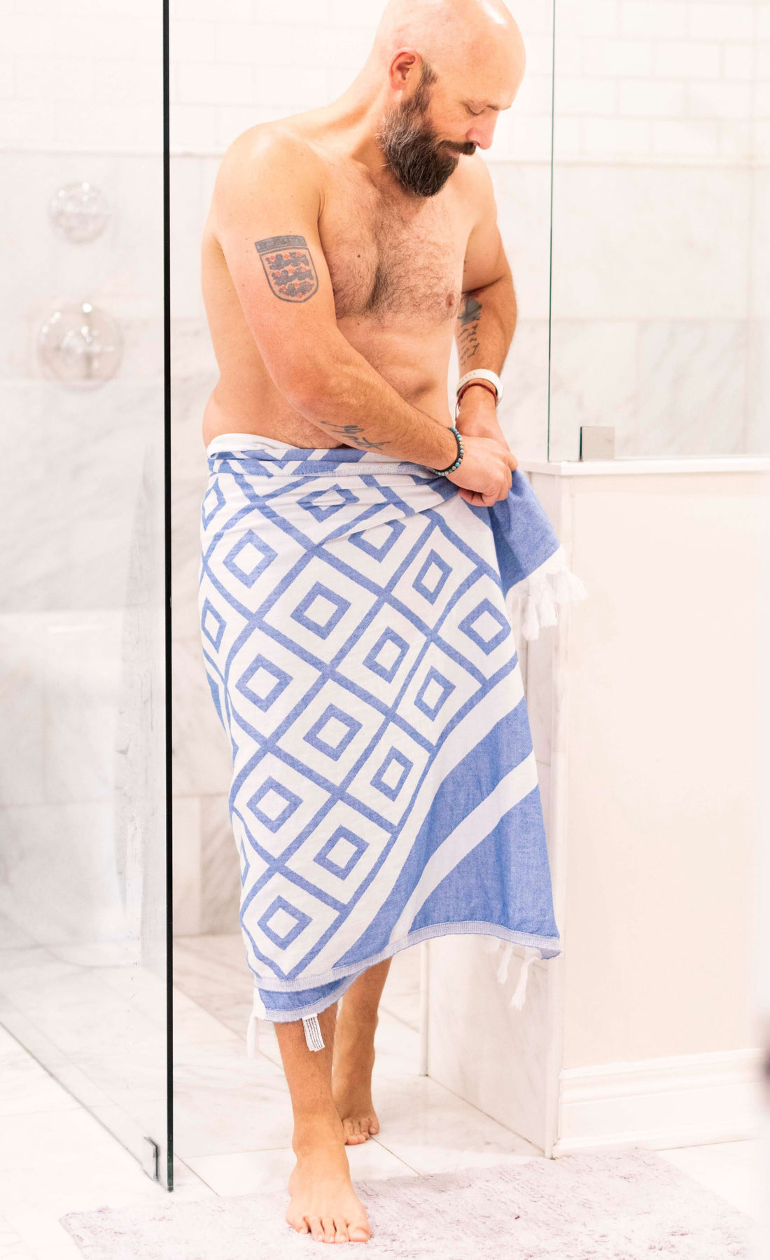 Man getting out of the shower with a Turkish towel