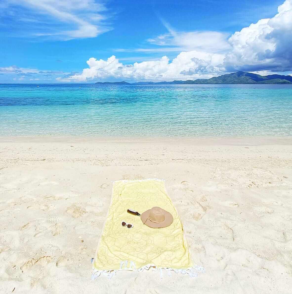 yellow orange Turkish towel on the beach in the Philippines