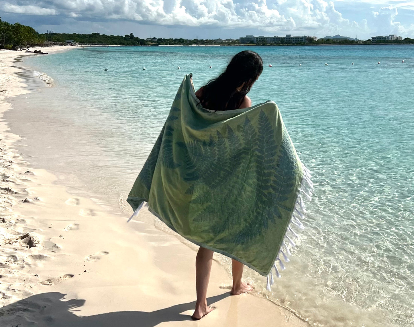 Green Turkish towel on the beach