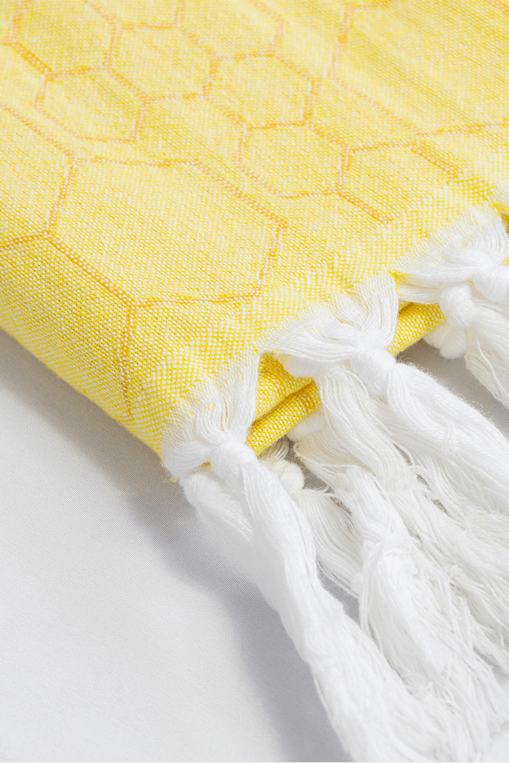 Yellow honeycomb Turkish towel in yellow orange with white tassels made with pure Turkish cotton