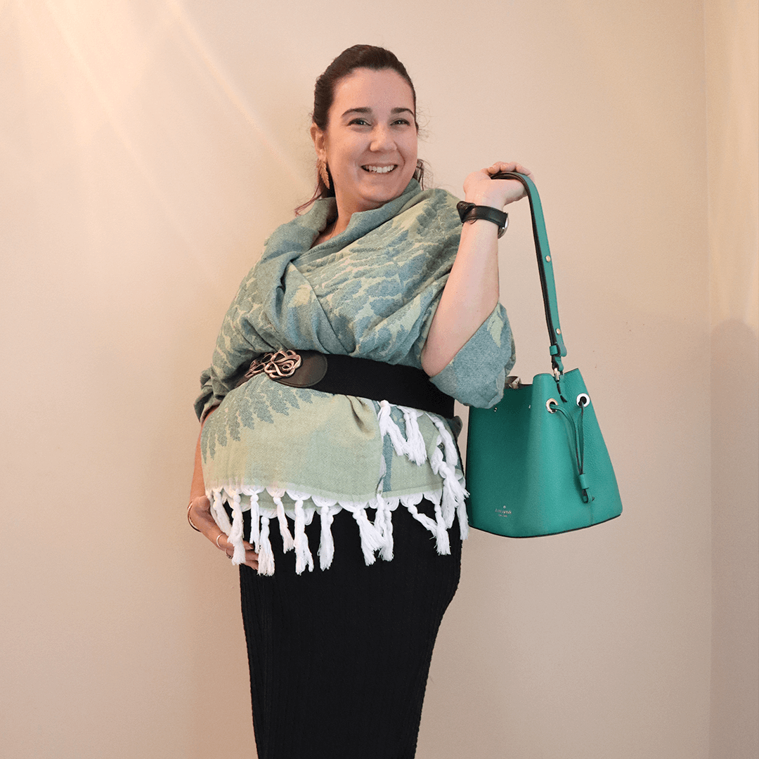 Pregnant woman using a green Turkish towel as a shawl with a belt