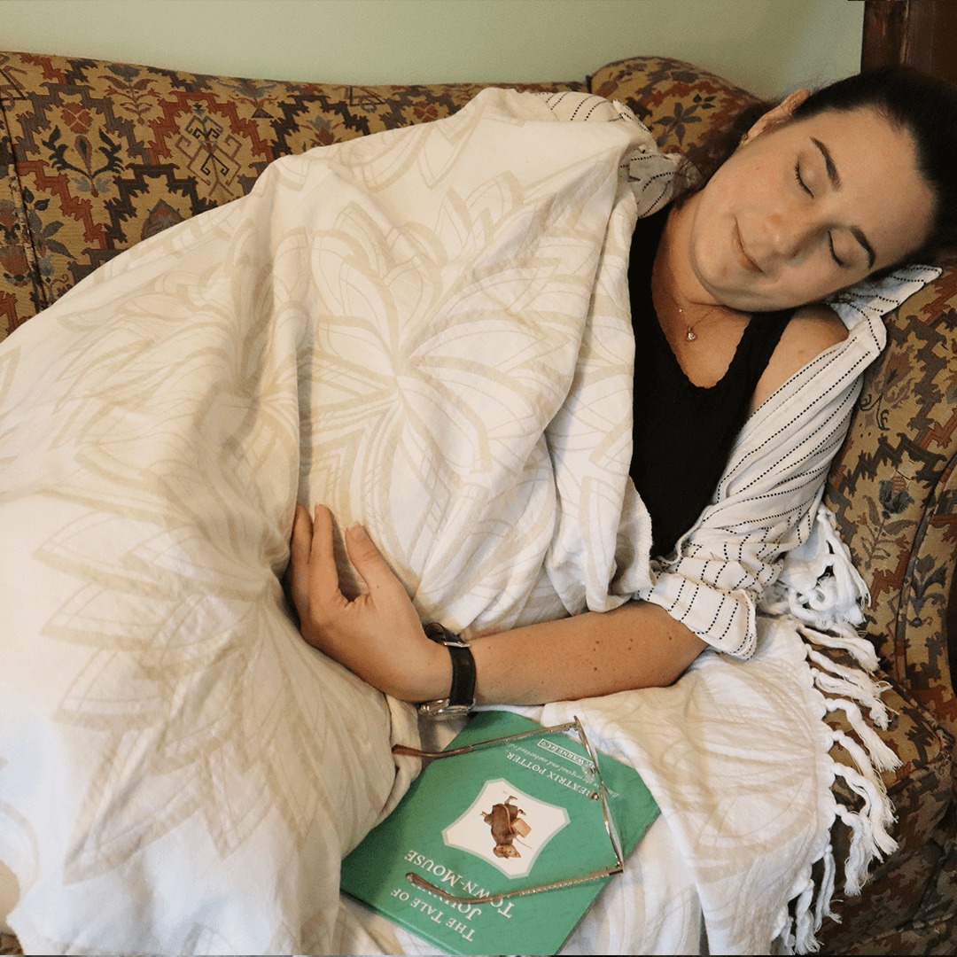 Pregnant woman taking a nap with her Turkish towel as a blanket