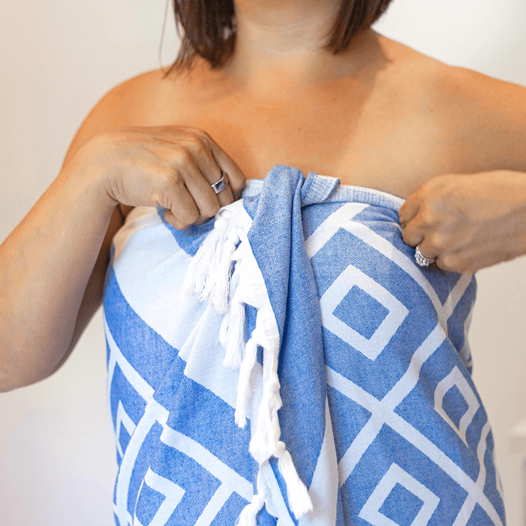 Woman wrapped in a blue and white Turkish towel