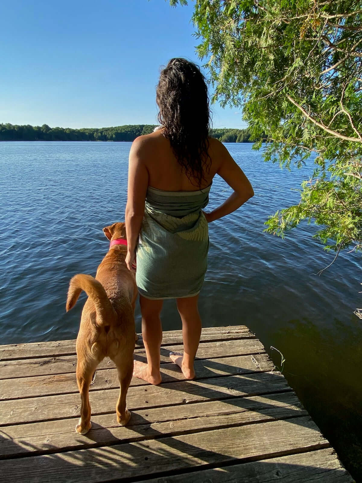 Woman and her dog on the dock with a Turkish towel