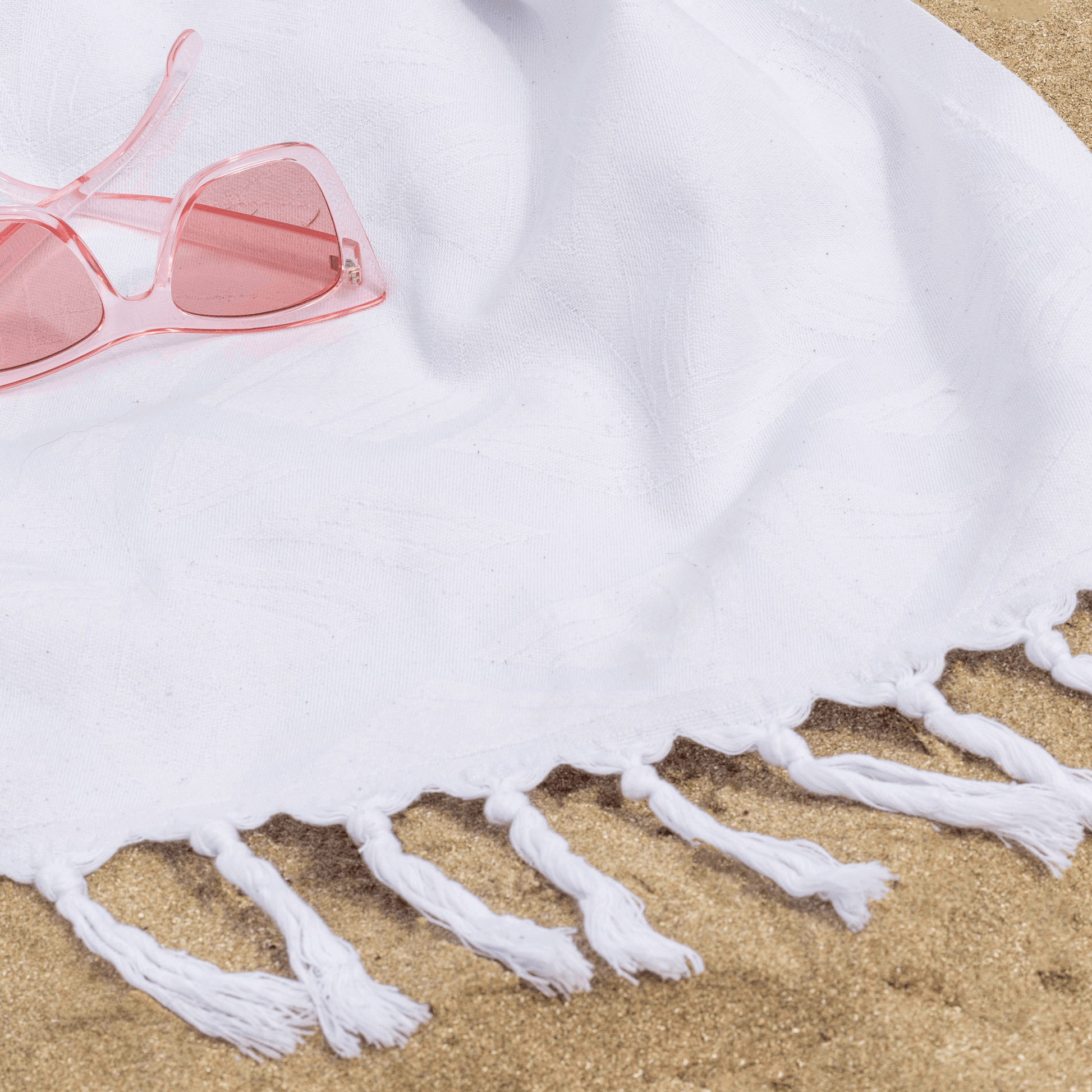 white Turkish towel at a beach