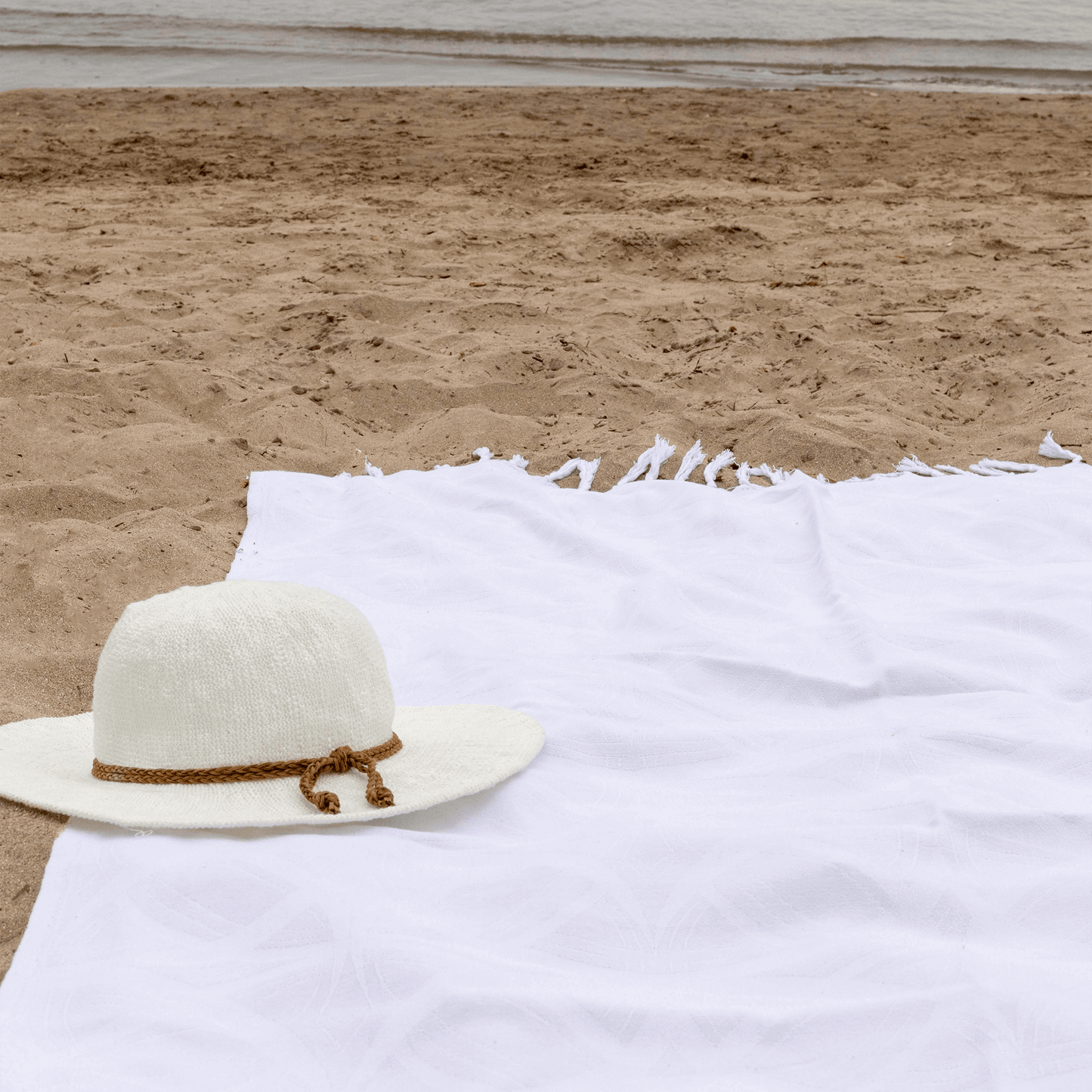 white Turkish towel at a beach