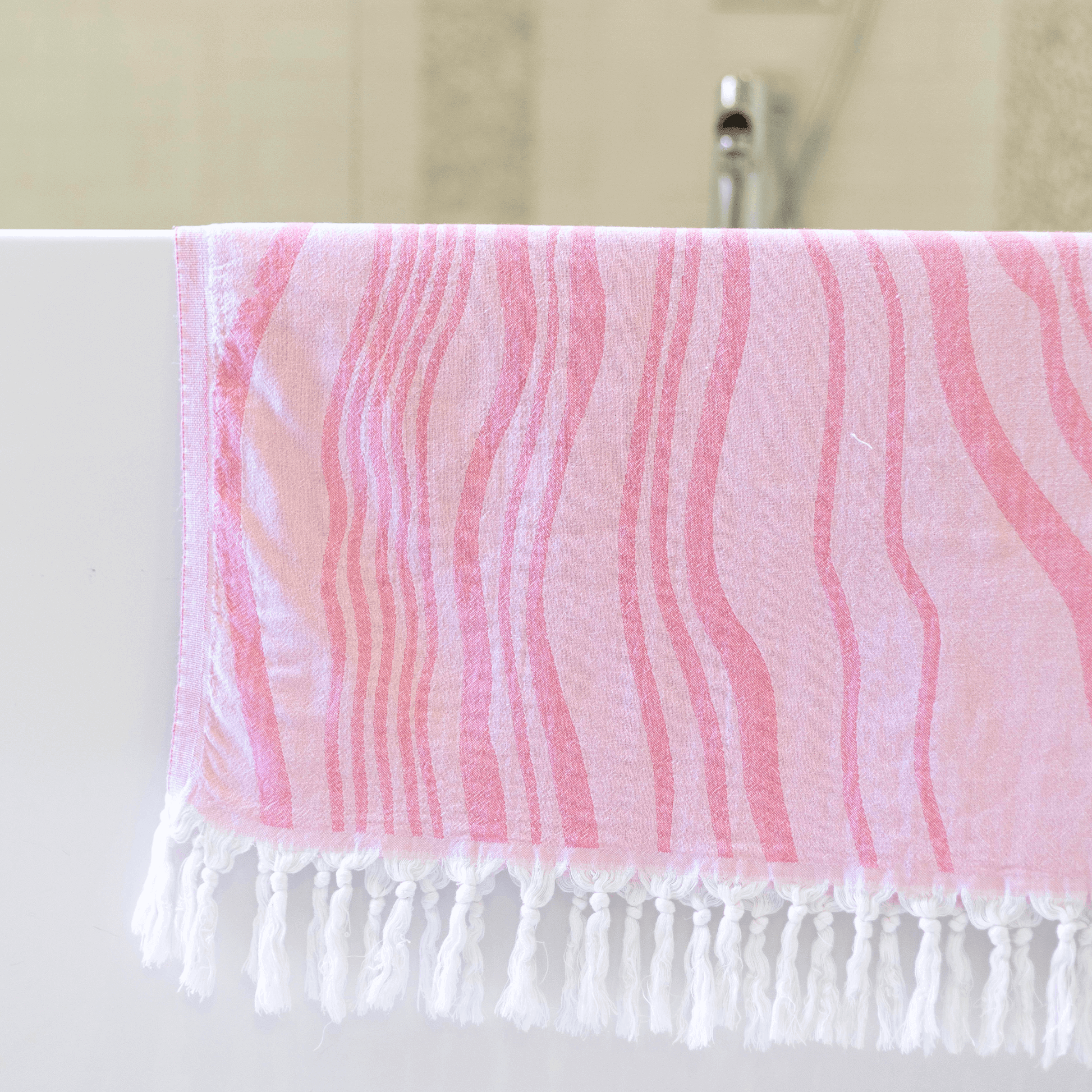 Pink stripped Turkish towel in the bath