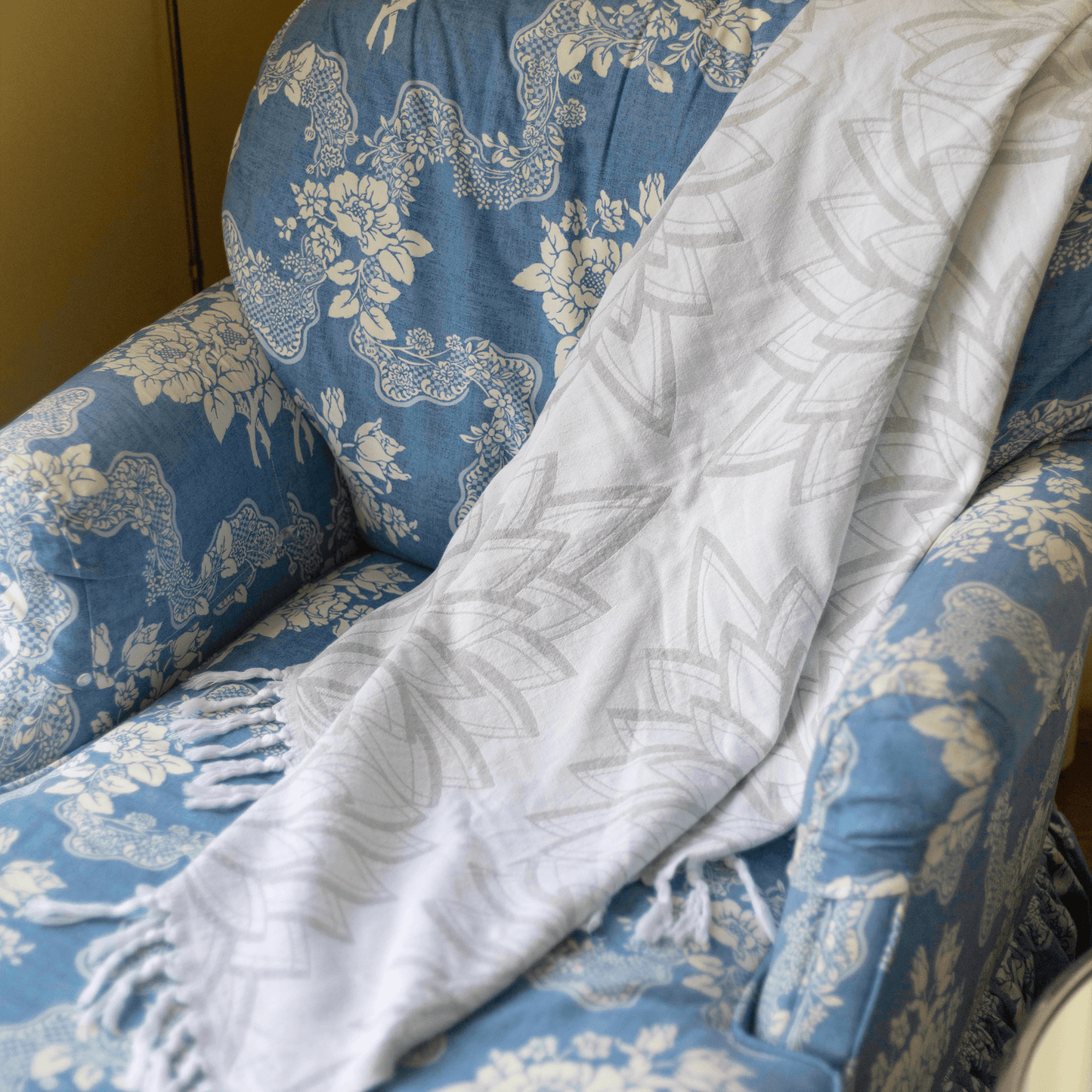 Grey and white Turkish towel on chaise lounge to be used as a light throw blanket