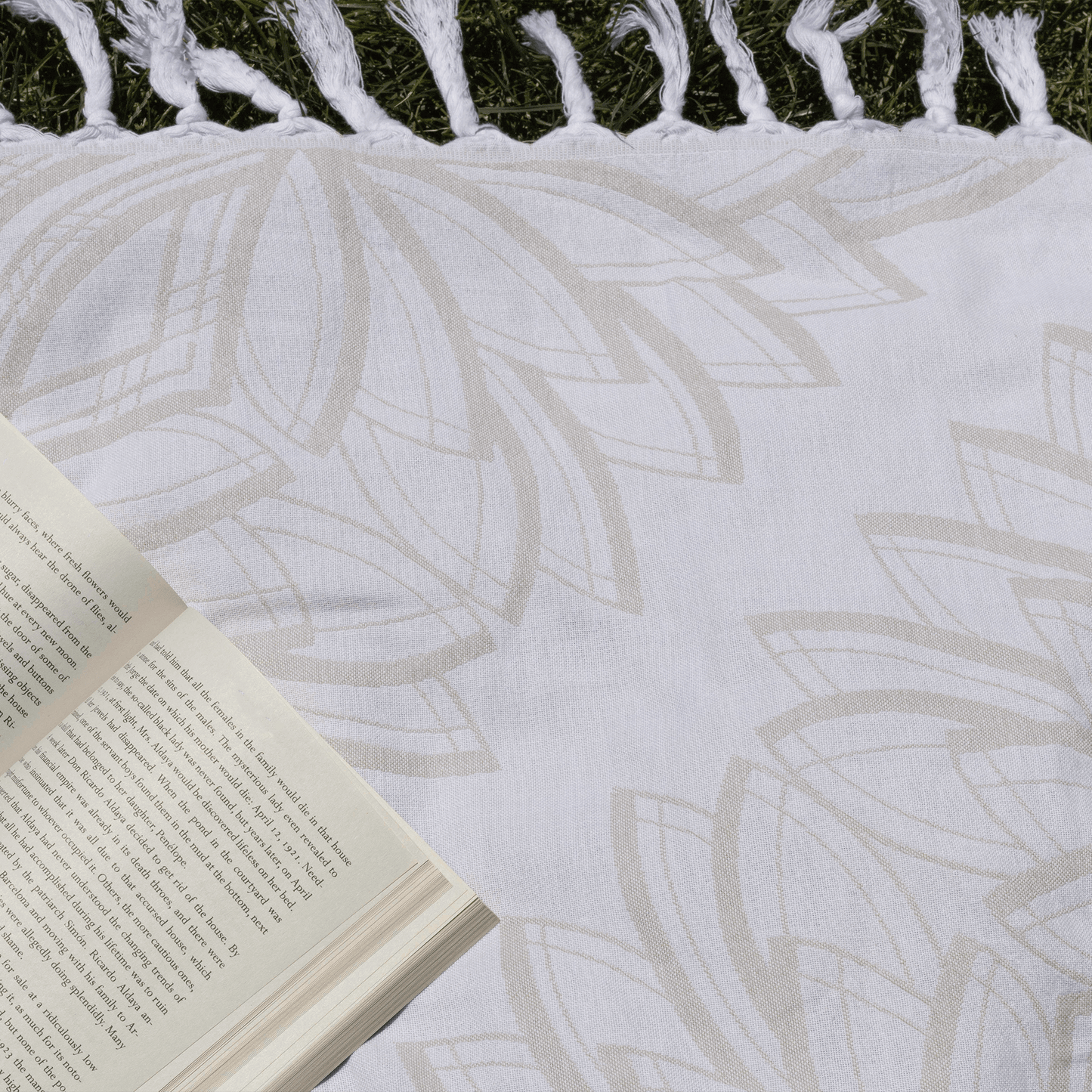 Turkish towel used for summer sunbathing with an open book