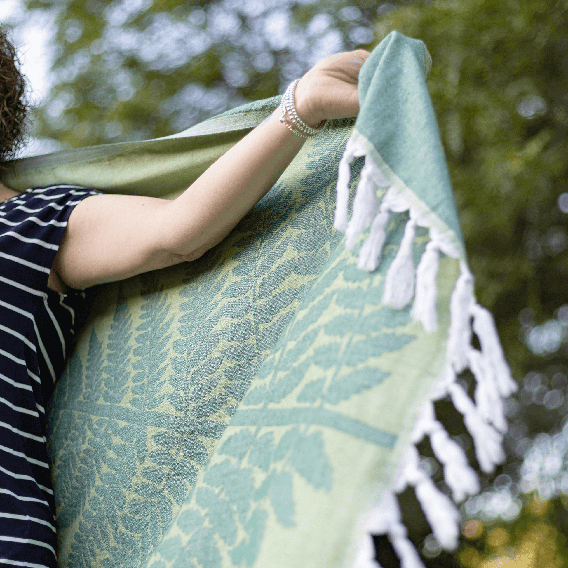 woman holding a green Turkish towel