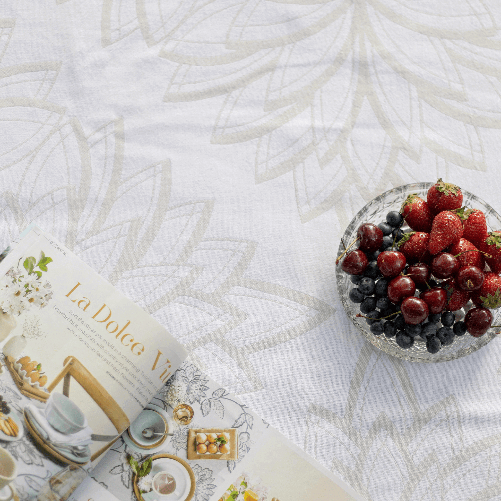 Turkish towel with strawberries and an open magazine 