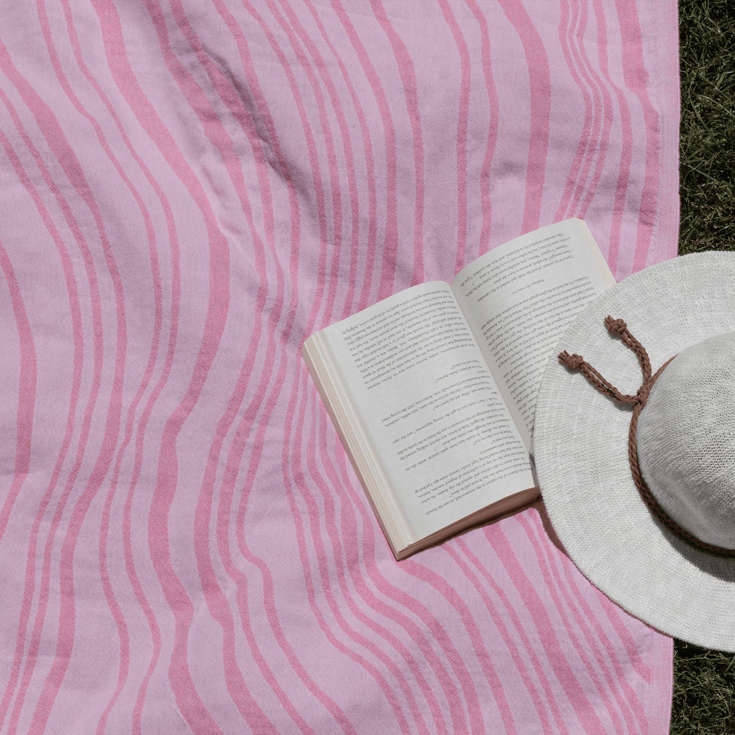 Pink Turkish towel in the summer with a booth and hat