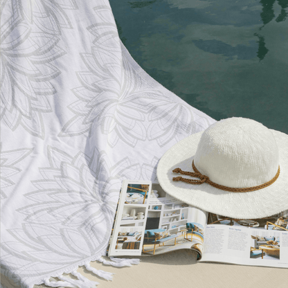 Grey and white Turkish towel poolside with sunhat