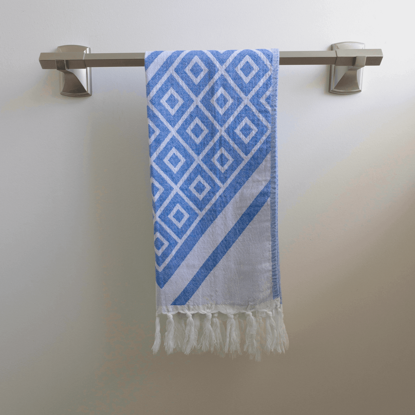 Blue and white hand Turkish Towel hanging on the towel rack