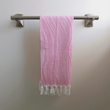 Pink Turkish hand towel hanging on the towel rack