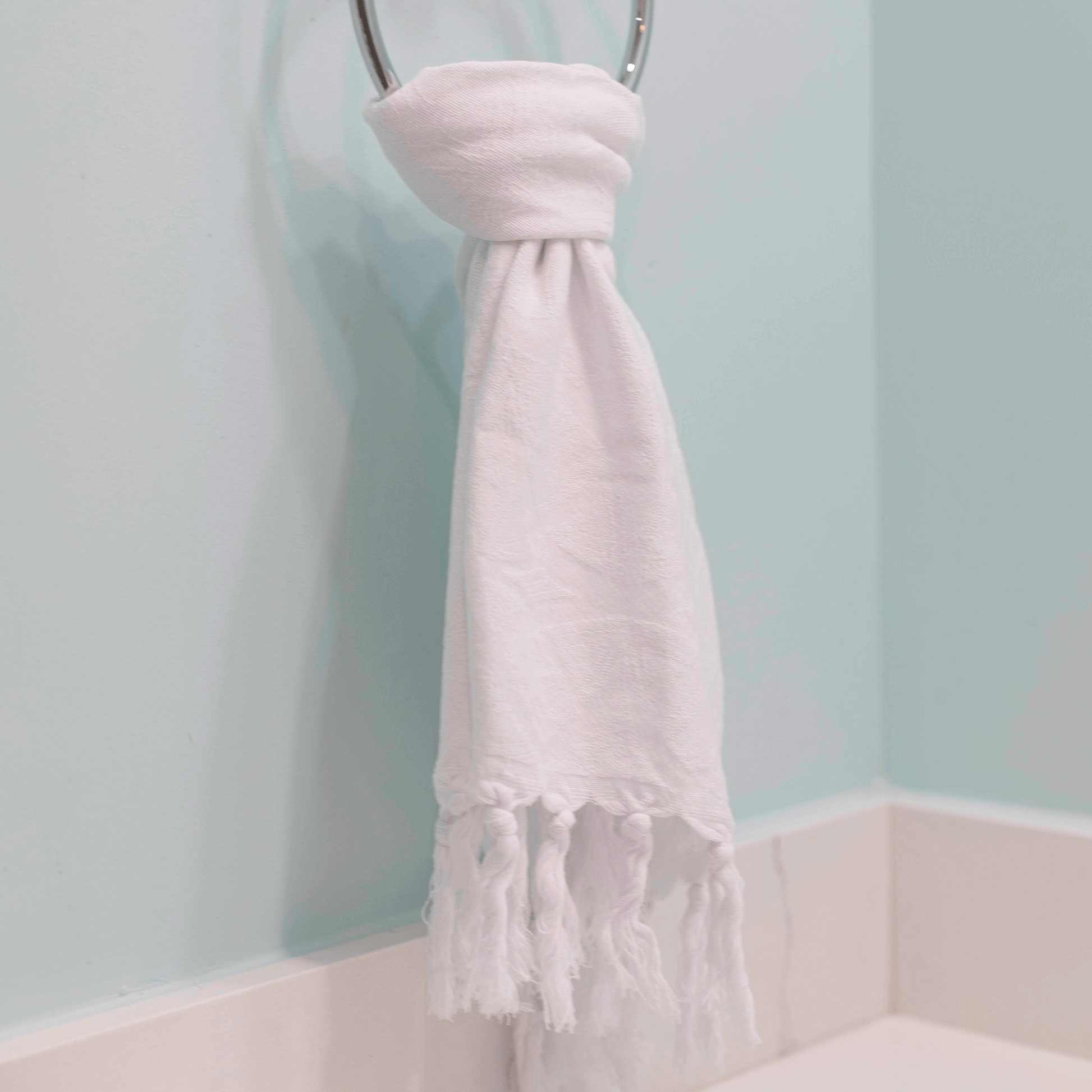  White Turkish towel hanging on hand towel rack