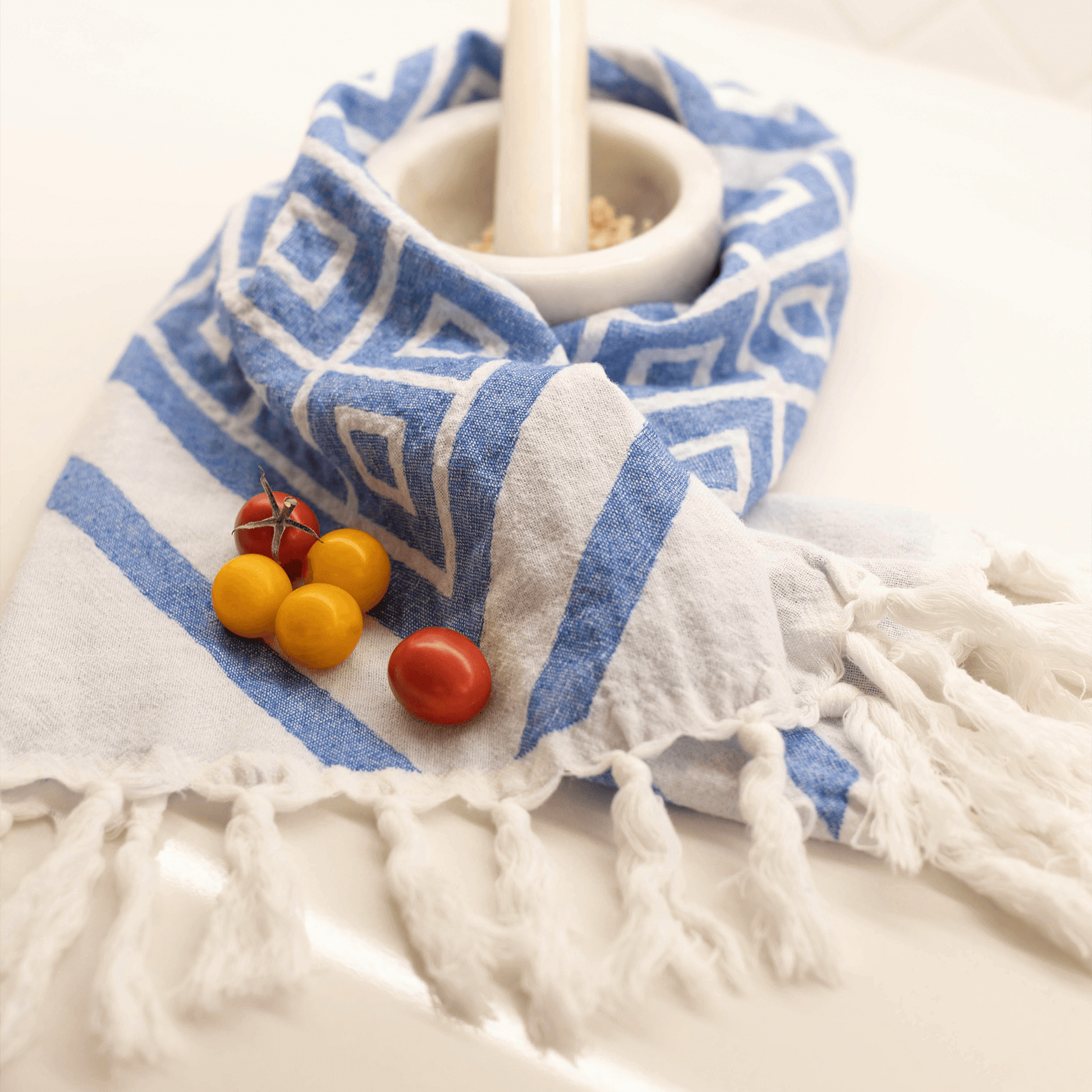 White and blue Turkish towel in the kitchen with a mortar and pestal