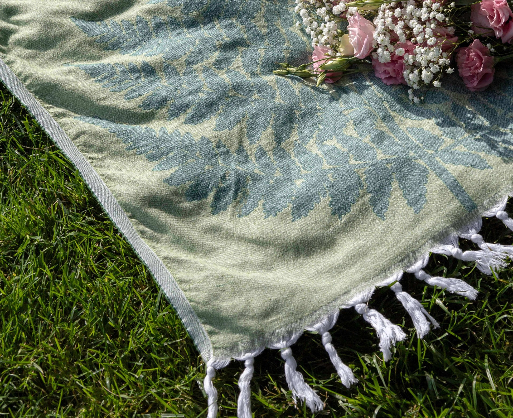 green Turkish towel at the park in the summer