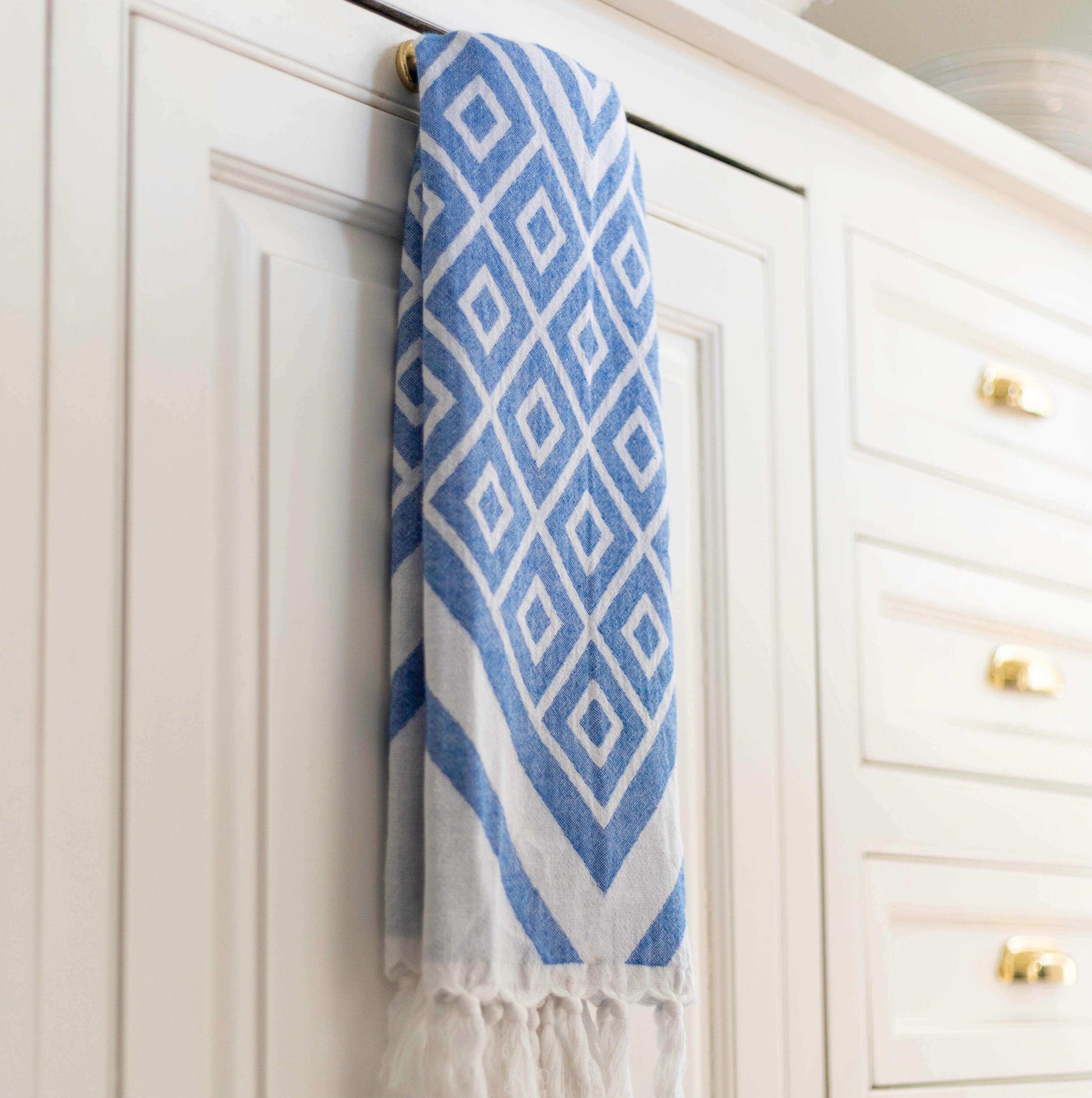 Blue and white hand Turkish Towel hanging in the kitchen as a tea towel