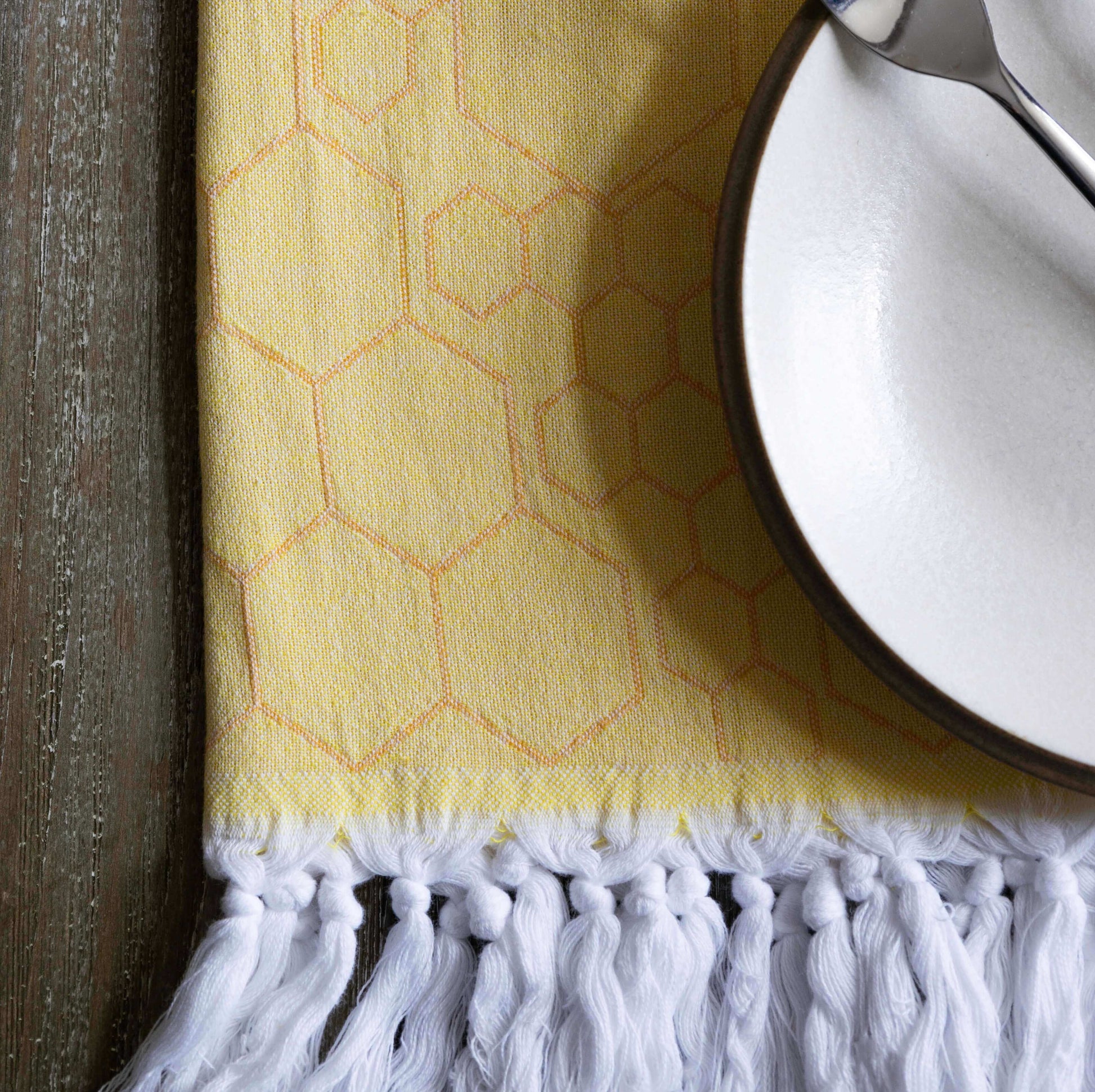 Yellow and orange Turkish towel with dinner plate