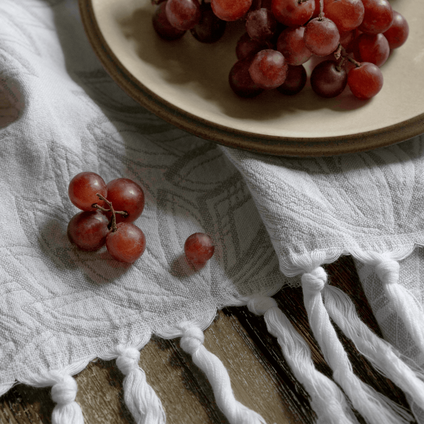 Grey and white Turkish hand towel with grapes in the kitchen