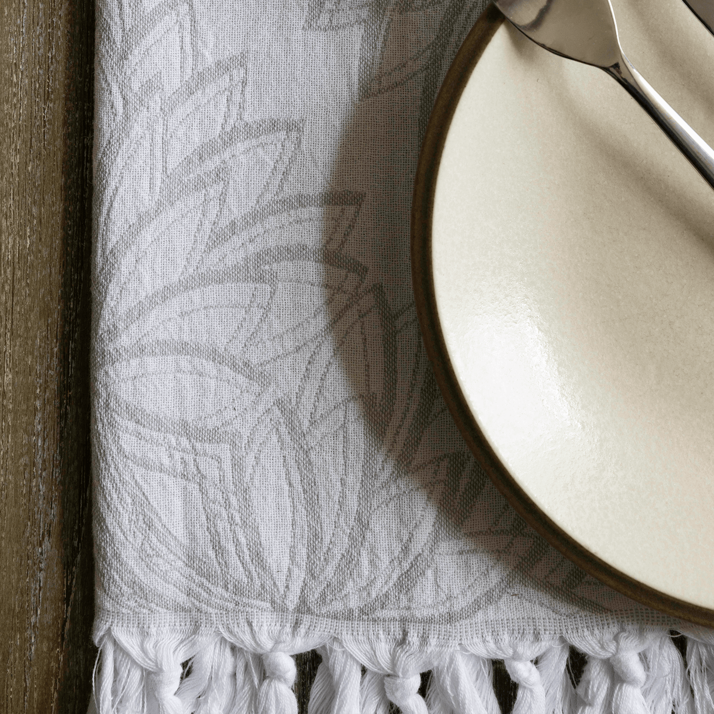 Grey and white Turkish hand towel with plate as a hand towel