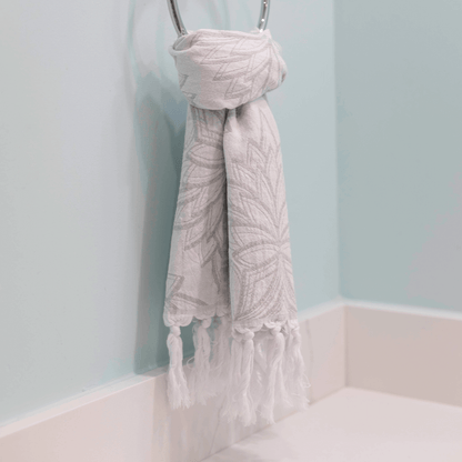 Grey and white Turkish hand towel hanging in the bathroom