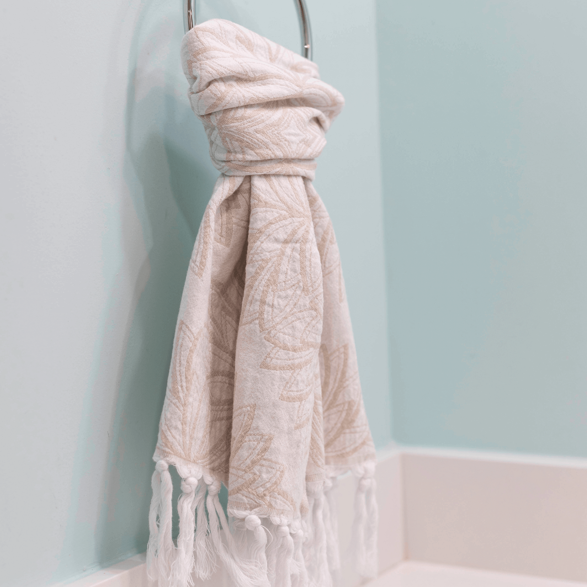 oat and white Turkish hand towel hanging in the bathroom