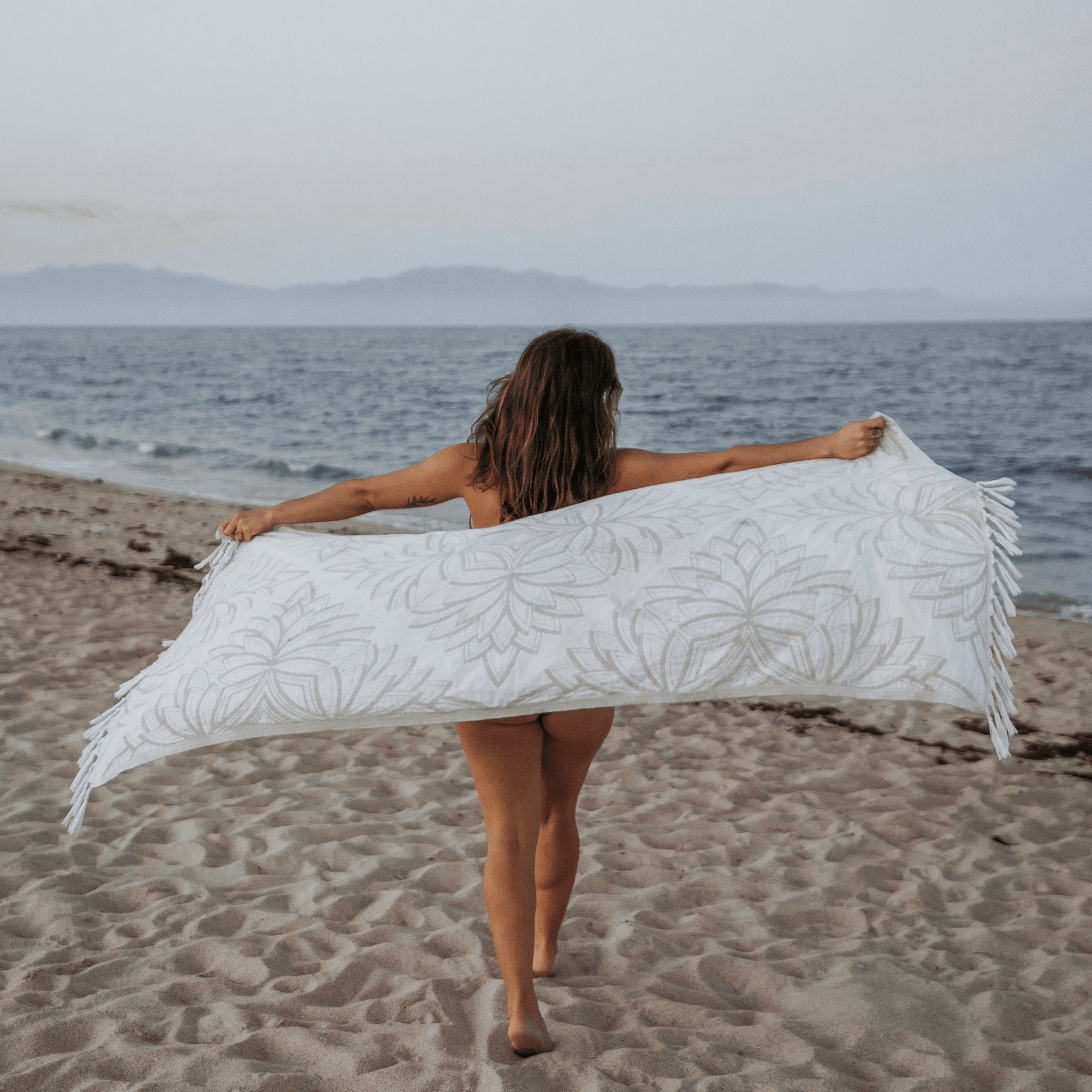 Woman at the beach using a Turkish towel